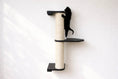 Charger l'image dans la visionneuse de la galerie, Wall-mounted cat scratching post with beige sisal-wrapped pole and black platforms by Catastrophic Creations