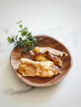 Load image into Gallery viewer, Beef tendon pieces (whole & halved) on a wooden plate with thyme sprigs