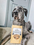 Load image into Gallery viewer, Beef Brain - Thin Cut dog treats by Naked Beasts in a brown paper pouch beside a gray dog.
