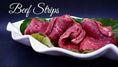 Load image into Gallery viewer, Angus beef thin-cut strips on a white curved plate with green leaves