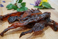 Load image into Gallery viewer, Naked Beasts turkey breast thin-cut jerky slices on a wooden board