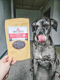 Load image into Gallery viewer, Lamb Liver Thin Cut dog treats in a kraft bag by Naked Beasts, shown next to a grey dog