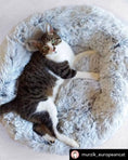 Load image into Gallery viewer, Mr. Peanut's 28-inch OrthoPlush pet bed in snowflake white two-tone; round fluffy pillow bed with a cat resting inside.
