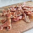 Load image into Gallery viewer, Chicken breast thin cut, fat-trimmed, Naked Beasts slices on a wooden cutting board