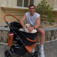Cargar la imagen en la vista de la galería, Furvelo Jogger Pet Stroller: black with brown leather accents, roomy basket, and a smiling dog inside.