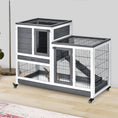 Load image into Gallery viewer, PawHut wooden rabbit hutch with white/gray panels, two-tier cage on casters, rabbit visible inside.