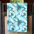 Load image into Gallery viewer, Jeffers Expression oversized fleece throw blanket in turquoise marble print, hung on railing