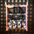Cargar la imagen en la vista de la galería, Jeffers Expression Trailer Door Horse Grooming Caddy with floral fabric, pink straps, and black mesh pockets