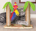 Load image into Gallery viewer, KONG Play Spaces Cat Tiki Twirl cat toy under lime-green palm leaves with a colorful parrot plush