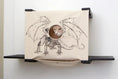 Carica l'immagine nel visualizzatore della galleria, Cat Cubby for Wall covered cat bed by Catastrophic Creations; beige fabric cube with dragon art and entry hole