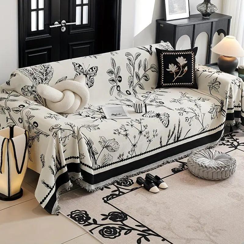 Soft & Cozy chenille reversible sofa cover in black and white with botanical print on couch