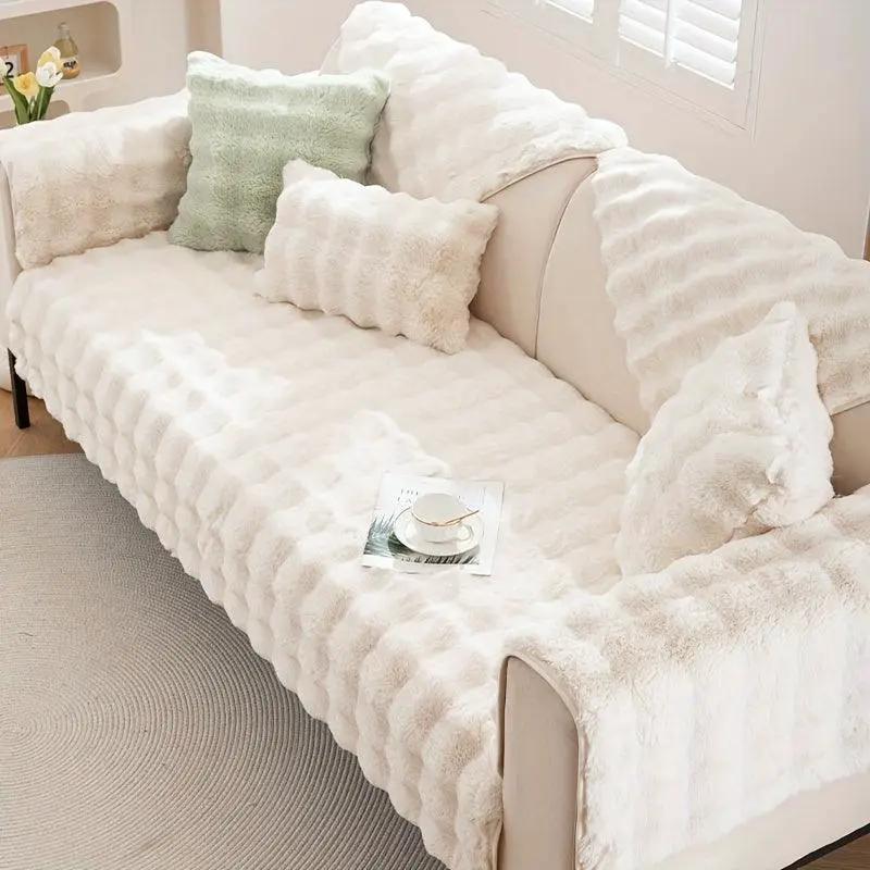 Molly Mutt Couch Cover on cream sofa; plush, soft non-slip protector with cream cushions.