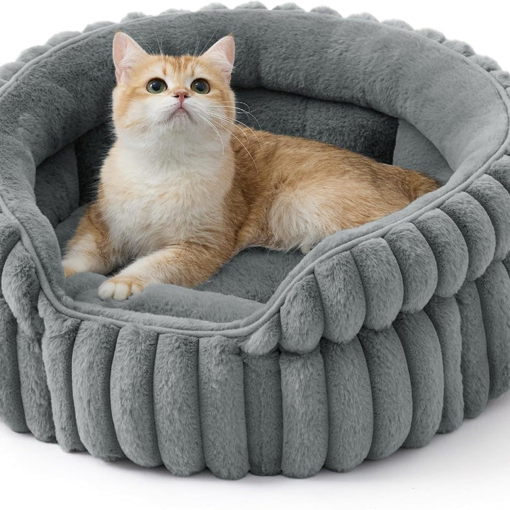 Cat sitting in warm-gray ribbed bed