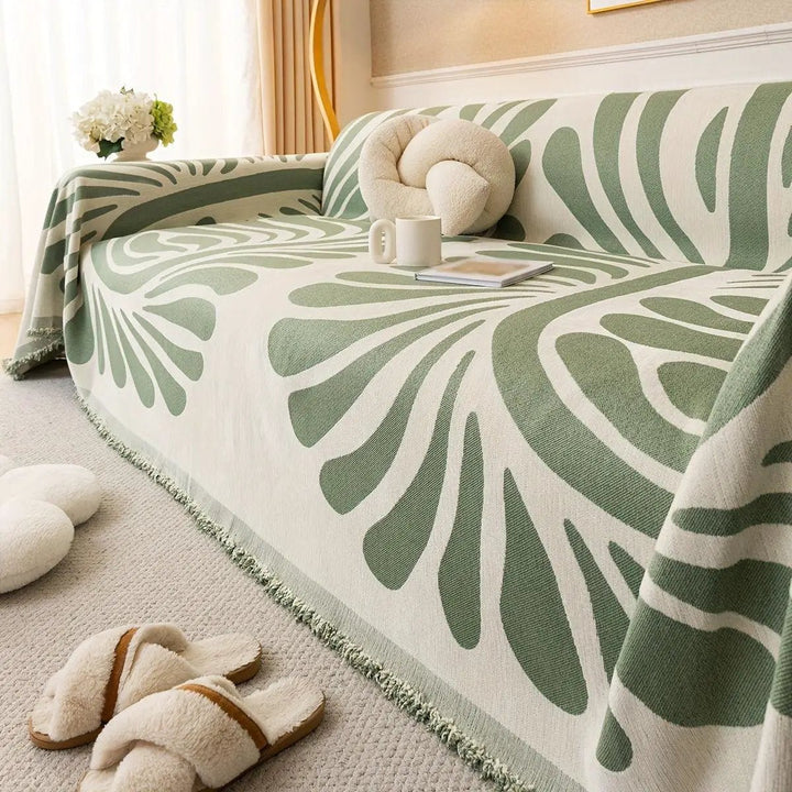 Versatile chenille sofa cover by topspet in green leaf pattern, draped over a sofa, pet-friendly.