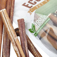 Charger l'image dans la visionneuse de la galerie, Brazilian Grass-Fed Beef Bully Sticks for pets; several brown sticks with white residue.
