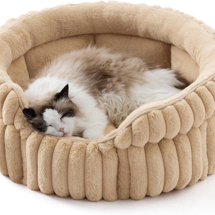 Cat resting in sand-beige ribbed bed