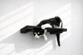 Load image into Gallery viewer, Wall Mounted Cat Shelf, black wooden perch with a black-and-white tuxedo cat hanging off.
