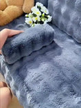 Load image into Gallery viewer, Couch slipcover in blue plush faux-fur fabric on a sofa with a rolled edge.

