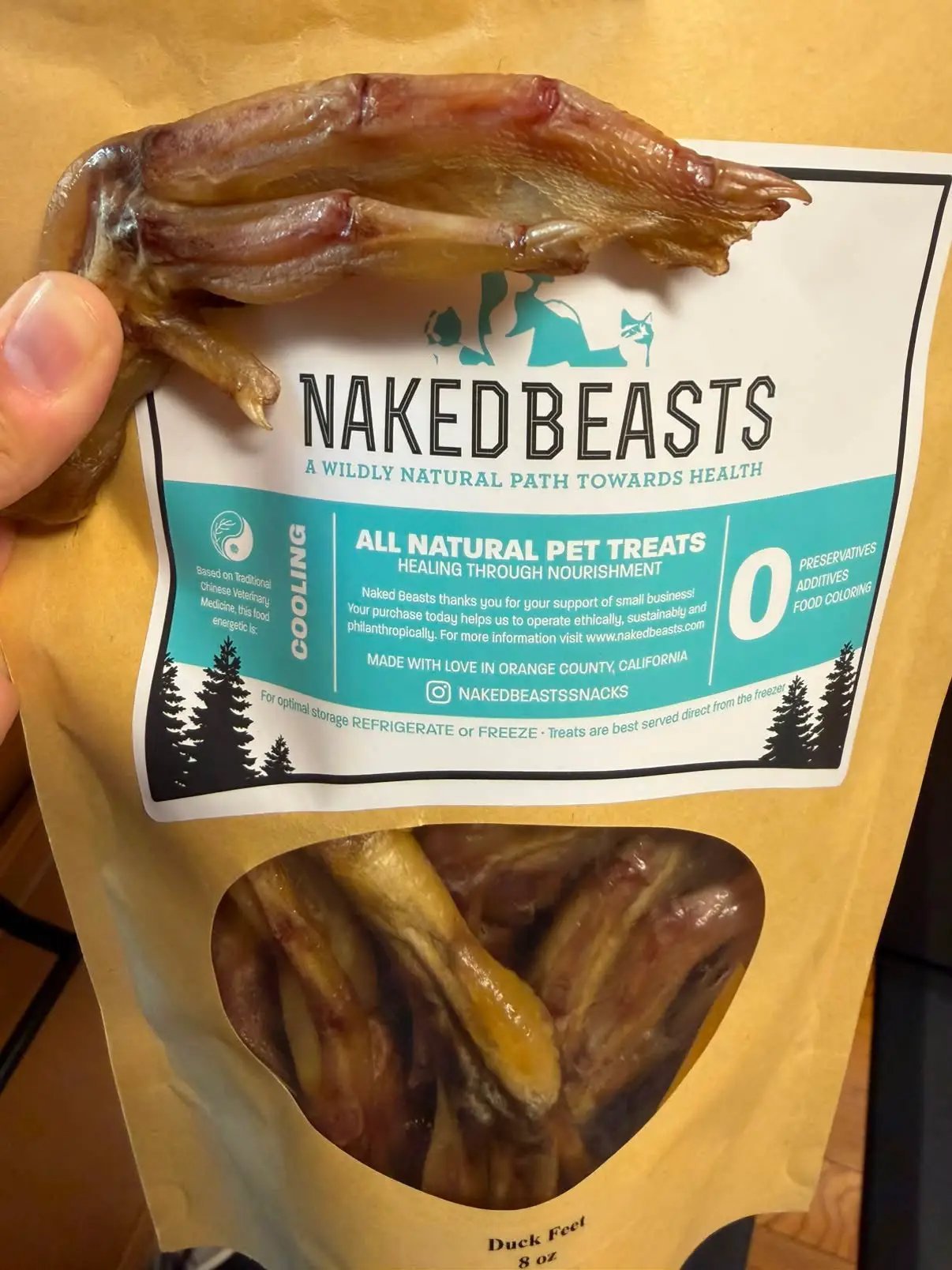 Duck Feet ABF all-natural pet treats by Naked Beasts; dried brown duck feet on packaging