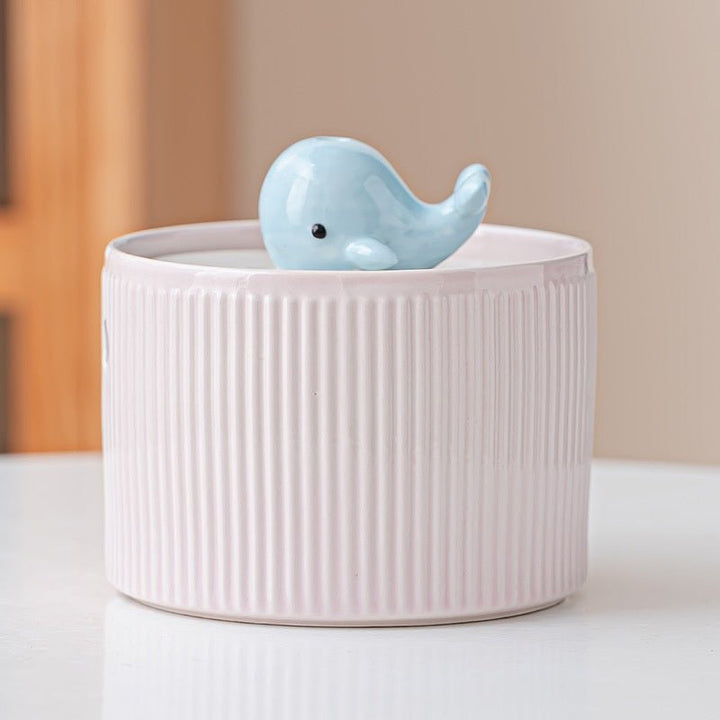 Pink ribbed fountain with whale centerpiece