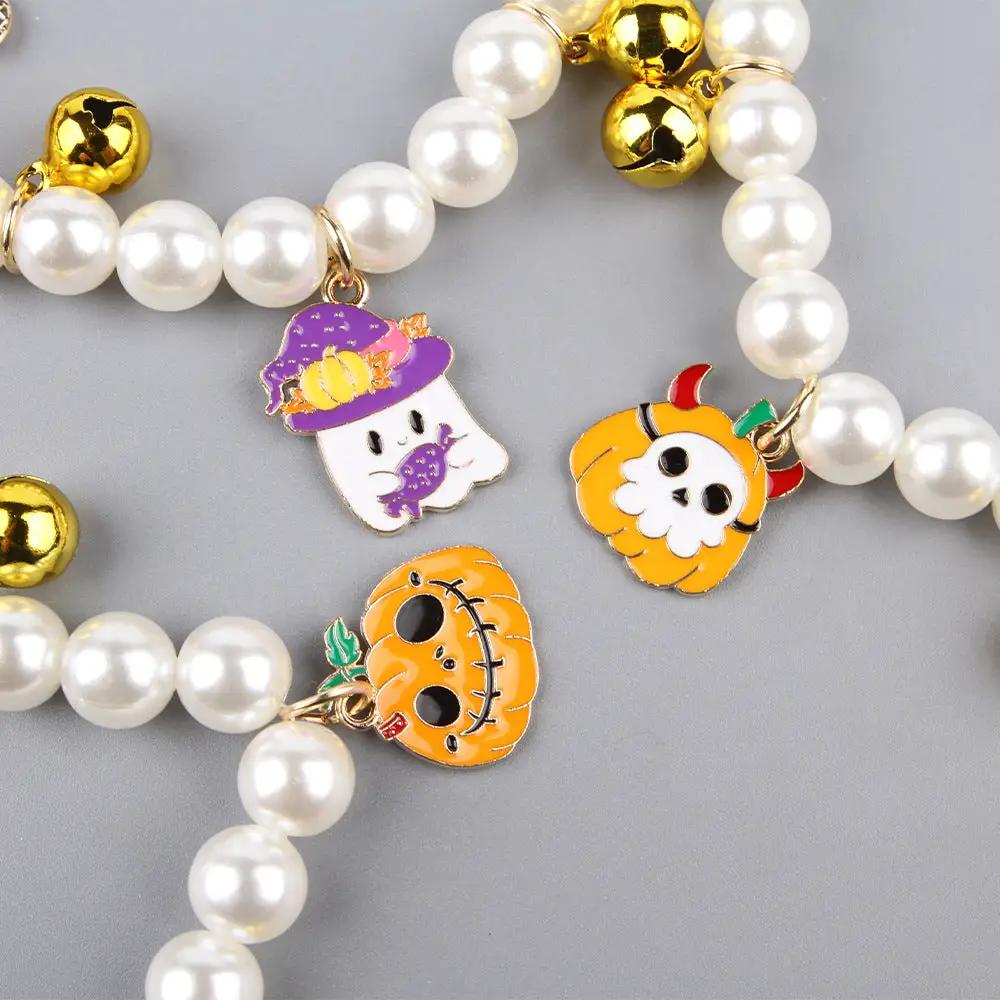 Halloween pet collar with charms featuring colorful ghost, pumpkin, and skull charms with pearl beads and gold bells.
