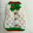 Load image into Gallery viewer, Pet Zen dog sweater in ivory hollow-out knit with green/red trim, bow, and wooden buttons
