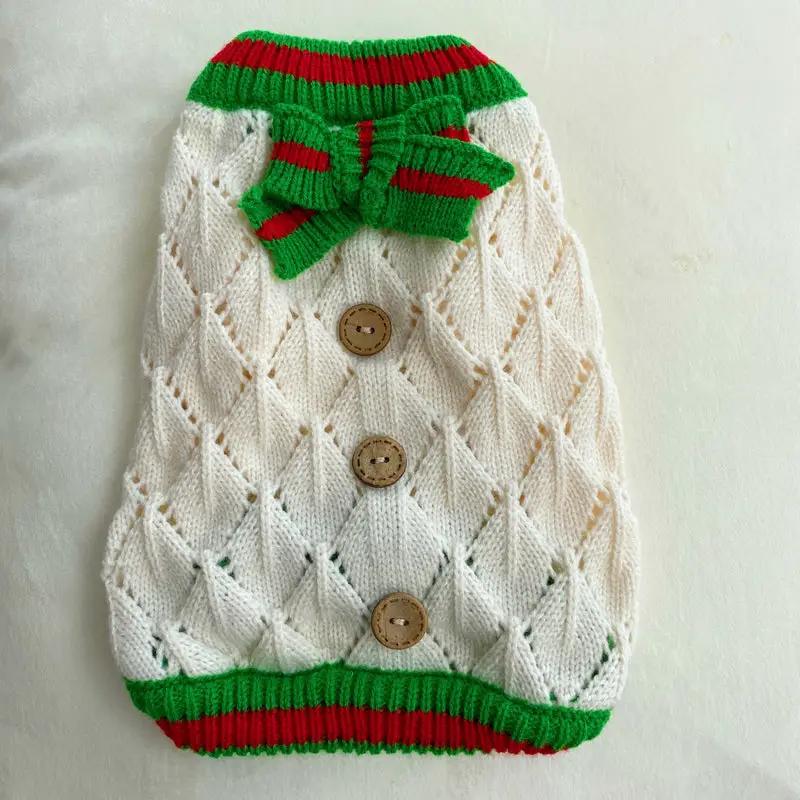 Pet Zen dog sweater in ivory hollow-out knit with green/red trim, bow, and wooden buttons
