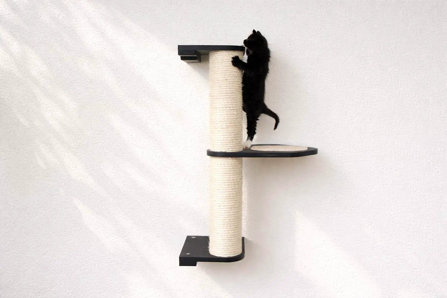 Wall Mounted Cat Climbing Pole - Sisal, a cat scratcher with a sisal-wrapped post and black platforms.