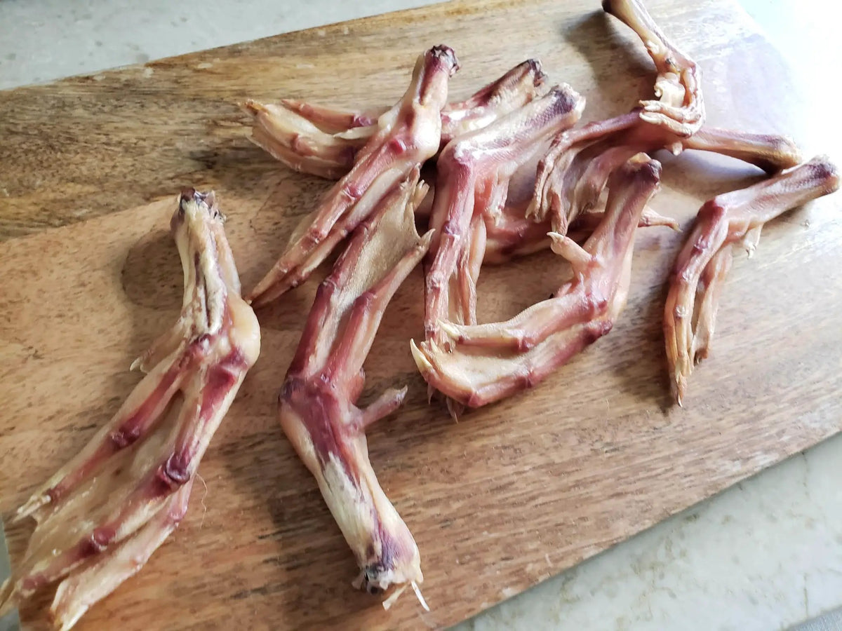 Duck Feet (ABF) by Naked Beasts, raw duck feet on a wooden cutting board