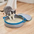Load image into Gallery viewer, Mr. Peanut's PortaPotty litter box for traveling kitties, gray with blue trim, cat nearby.
