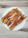 Load image into Gallery viewer, Beef tendon pieces (whole & halved), Naked Beasts; several fried pieces on a white plate
