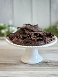 Load image into Gallery viewer, Turkey Heart sliced jerky for small animals; dark brown dried treats on a white cake stand.
