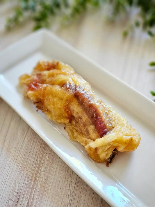 Beef tendon on a white rectangular plate, crispy golden-brown exterior
