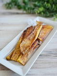 Load image into Gallery viewer, Beef backstrap treats by Naked Beasts, grass-fed and finished with fat trimmed, on a white plate
