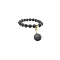 Load image into Gallery viewer, The Black Volcanic Diffuser Charm dog collar by Bark Fifth Avenue; black lava beads with gold-tone spacers.
