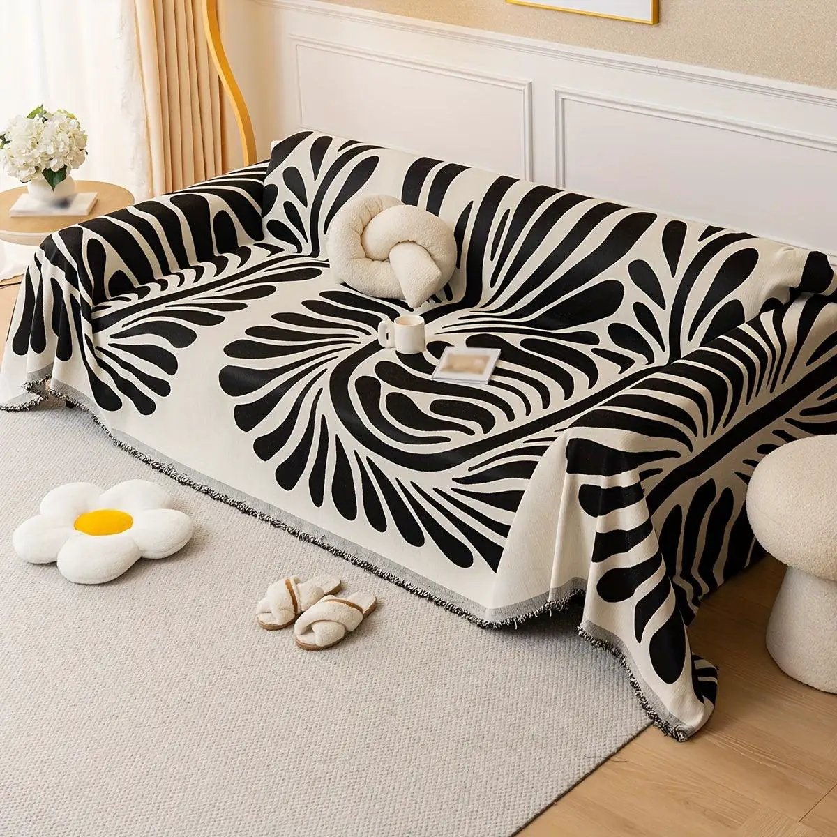 Versatile chenille sofa cover in cream with a bold black abstract pattern for chairs and sofas.