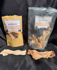 Load image into Gallery viewer, Beef tendon from Naked Beasts, whole and halved, in yellow and gray bags with visible tendon pieces.
