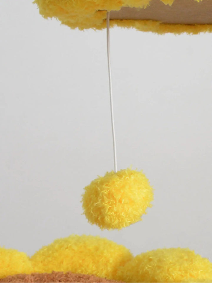 Yellow ball hanging from a cord beneath a flower-shaped perch on the Solana Sunflower Cat Tree