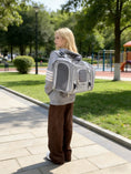 Charger l'image dans la visionneuse de la galerie, Mr. Peanut's Monterey Series airline-compliant horizontal backpack pet carrier worn as a backpack by a person in a park.
