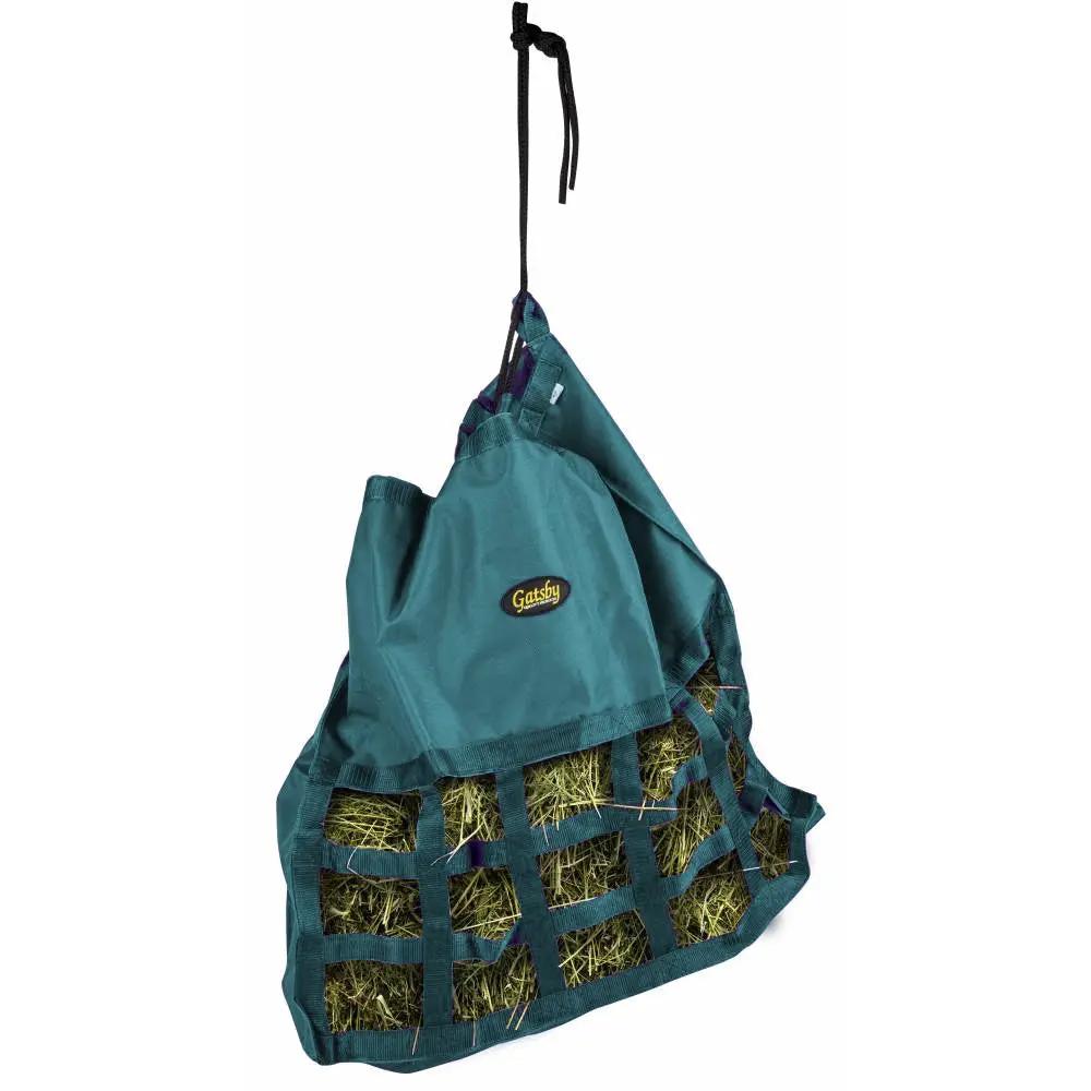 Gatsby Nylon Scratchless Slow Feed Hay Bag by StateLineTack in teal, hanging with hay-filled mesh.