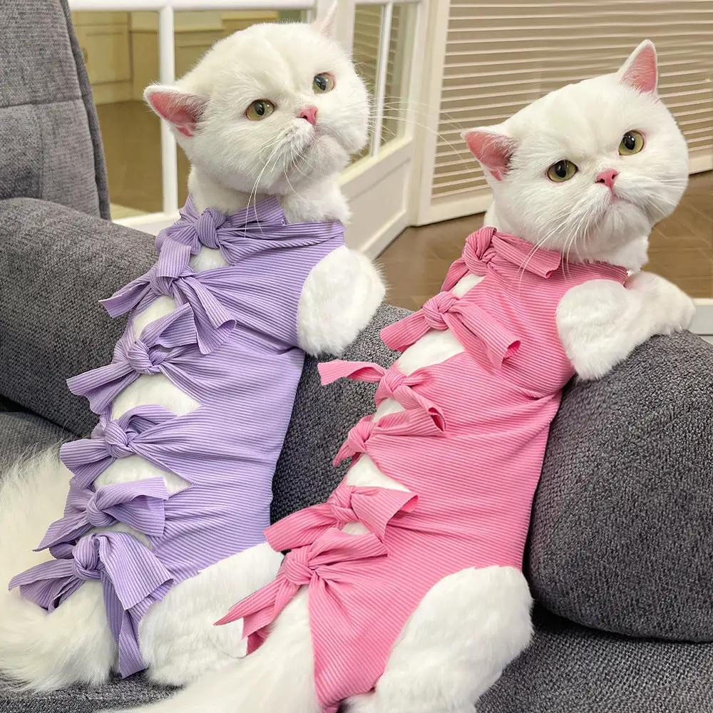 Lace-up Cat Sterilization Clothing for post-op recovery; two white cats in purple and pink polyester outfits.