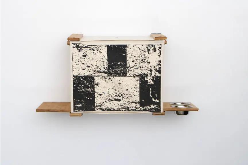 Deluxe Cat Cubby Bed wooden cube with black/white distressed checker front; side shelves and a metal bowl.