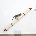 Carica l'immagine nel visualizzatore della galleria, Slanted Cat Scratcher for Wall with beige sisal rope and brown wood ends; cat climbing on it.
