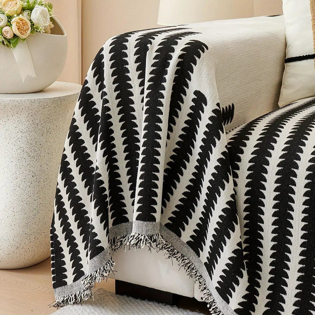 Chenille fabric sofa cover with black and white geometric pattern and fringe edges