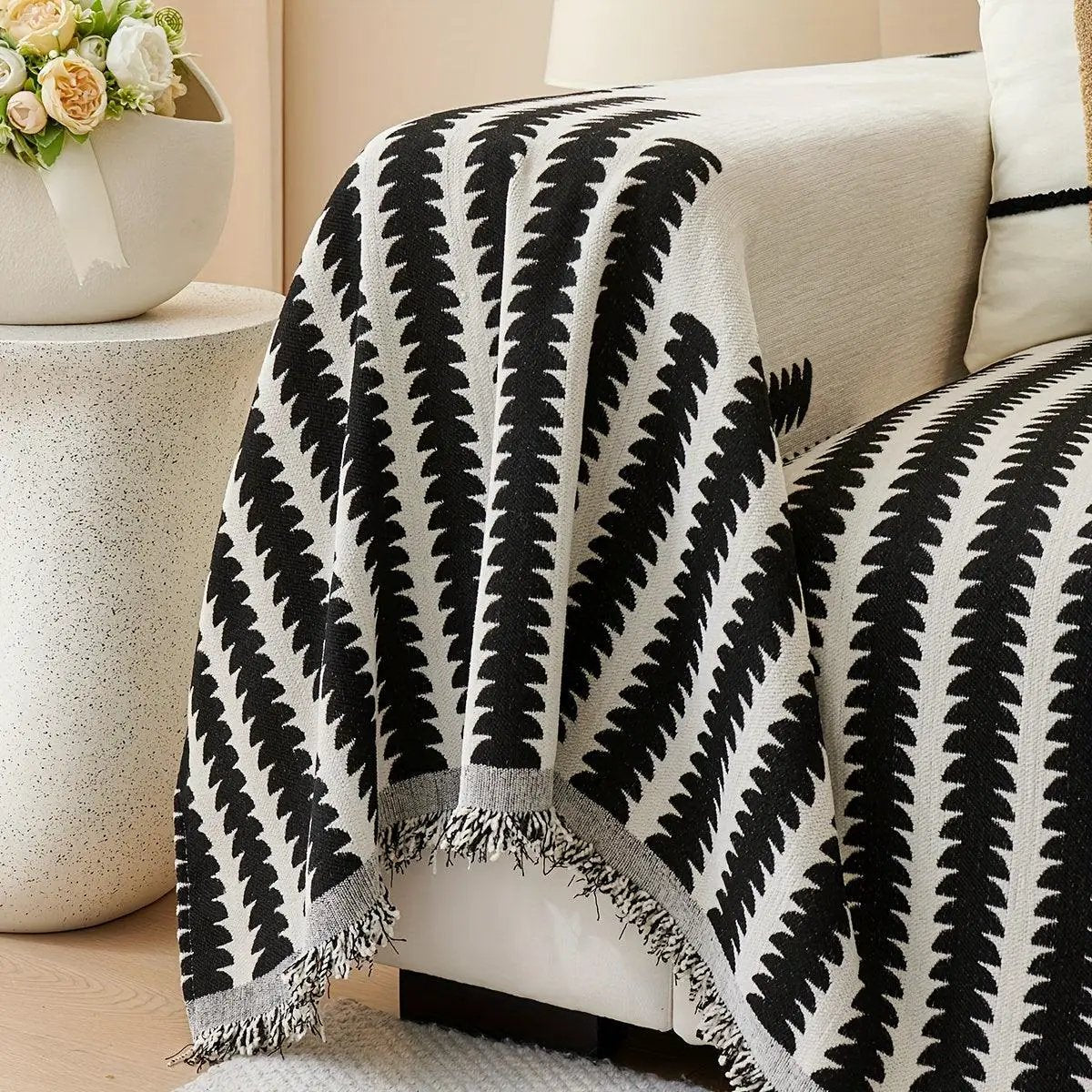 Chenille fabric sofa cover with black and white geometric pattern and fringe edges