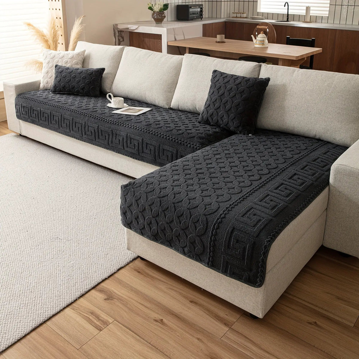 L-shaped couch cover in dark gray textured fabric on beige sofa