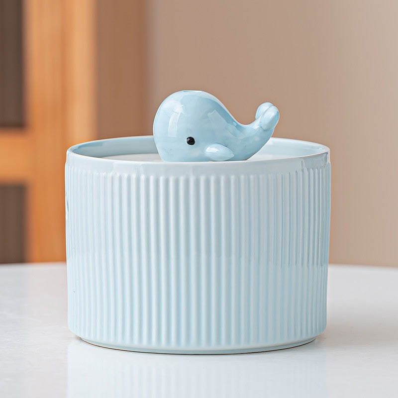 Blue ribbed fountain with whale centerpiece