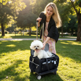 Load image into Gallery viewer, Mr. Peanut's Gold Series Expandable V3.0 Pet Carrier; black wheeled carrier with expandable interior and a white fluffy dog.
