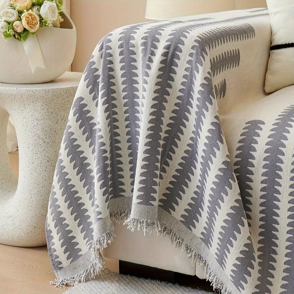 Chenille sofa cover with gray chevron pattern and fringed ends