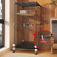 Carica l'immagine nel visualizzatore della galleria, Large black rolling bird cage with perches, feeding bowls and removable tray on wheeled stand; two birds inside.

